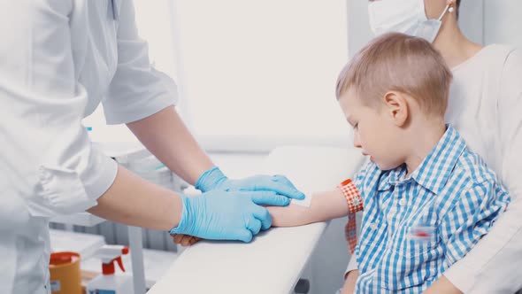 Little Boy is Taking Blood From a Vein for Analysis