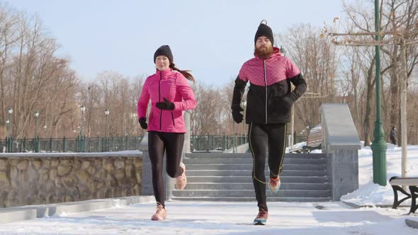 Slow Motion Fit Couple Jogging in Winter