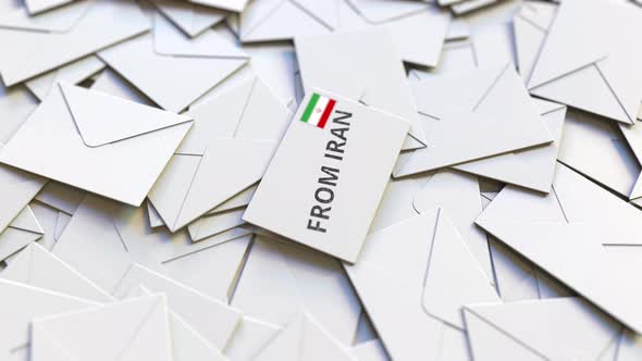 Envelope with From Iran Text on Pile of Other Envelopes alt