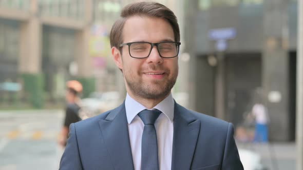 Portrait of Businessman Shaking Head as Yes Sign