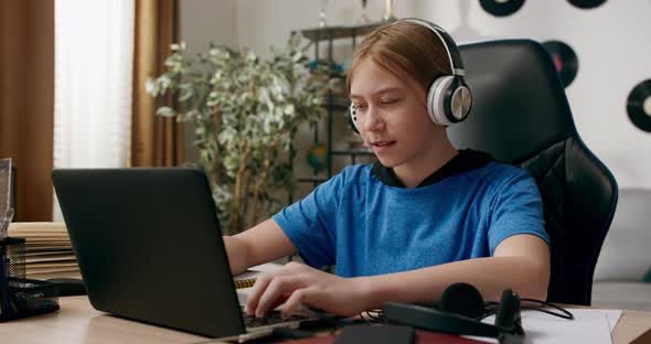 Teenager Uses Laptop Texts Friends Listens to Music on Wireless Headphones Games More Important Than alt