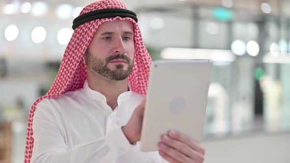 Arab Businessman Using Digital Tablet, Browsing Internet