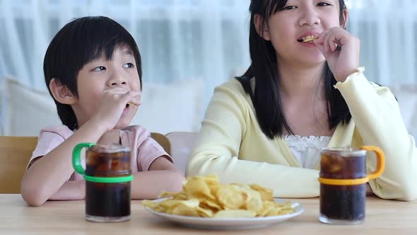 Asian Children Eating Snack Together