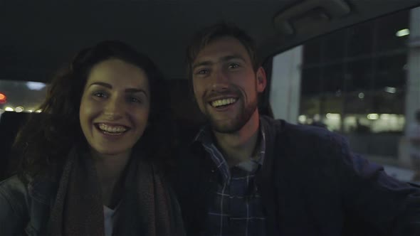 Couple riding in car in city