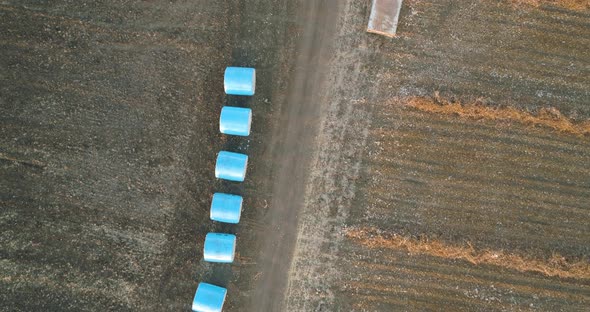 Aerial view of a tractor loading cotton bales on truck, Israel.