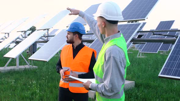 A Team of Professional Engineers Learning the Design of the Solar Plant Paper Plan.