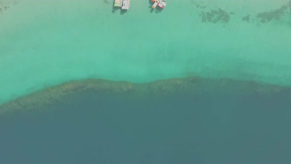 Aerial view of Kournas Lake, in Greece. Little pier with pedal boats