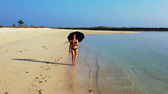Ladies look beautiful on relaxing coastline beach wildlife by turquoise ocean with white sandy backg