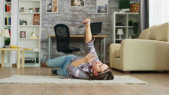 Little Girl Lying on the Floor Taking Selfies