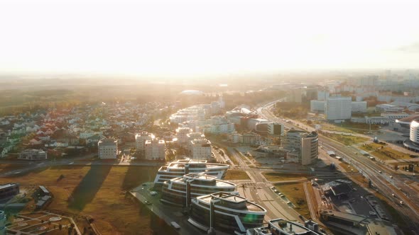 Drone Flying Above Modern City Buildings and Parks Panorama in Minsk, Belarus During Sunrise on