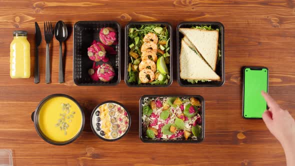 Food Delivery Top View Take Away Meals in Disposable Containers on Wooden Table