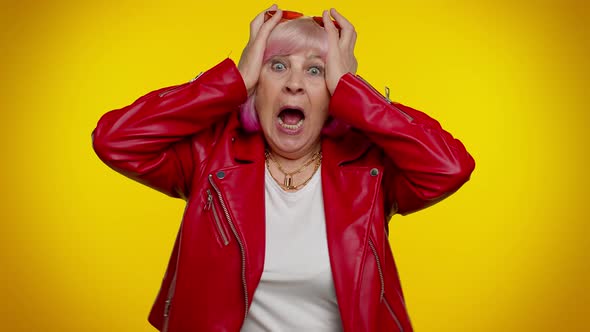 Excited Amazed Senior Woman Raising Hands in Surprise Looking at Camera Shocked By Sudden Victory