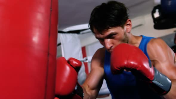 Boxer practicing boxing with punching bag