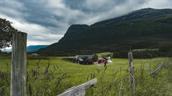 Red Barn And Farmhouse Built By The Mountains Of Hemsedal Norway - timelapse shot