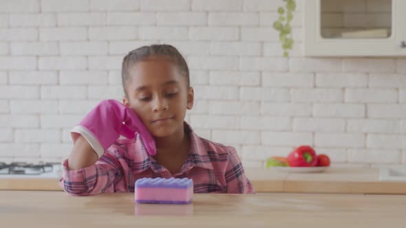 Exhausted Little Girl Tired of Cleaning in Kitchen alt