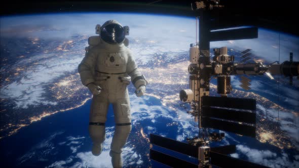 International Space Station and Astronaut in Outer Space Over the Planet Earth alt