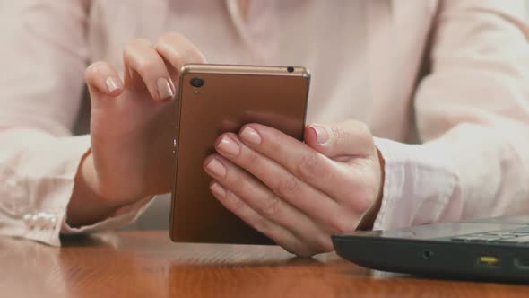 Hands of Businesswoman Scrolling on Smartphone, Chatting with Client Online