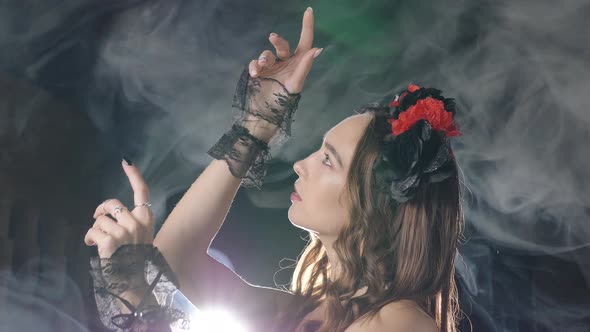 Young Model Dressed Up for Halloween Poses in Smoke Clouds