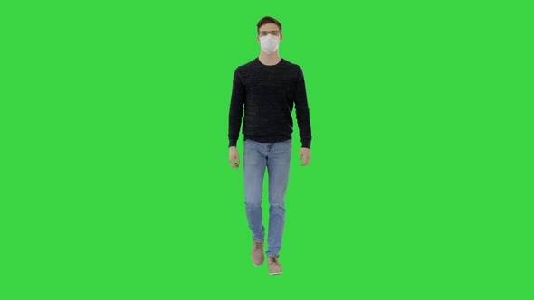 Student in Antiviral Mask Walking on a Green Screen, Chroma Key.