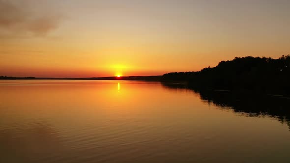 River at sunset. Flight over the evening water. 