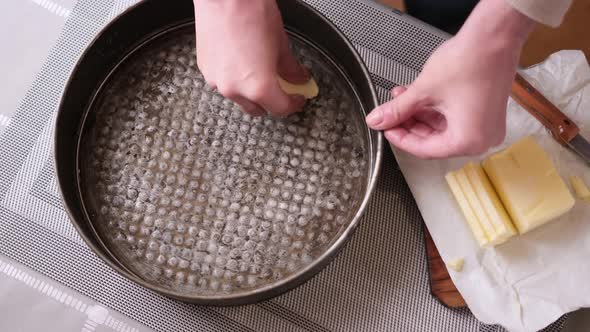 Closeup Video of Woman Buttering a Cake Pan for Baking Cake