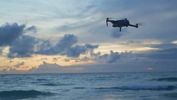 Drone Flying In Cloudy Sunset.