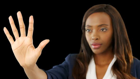 Businesswoman touching a transparent screen