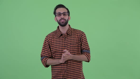 Happy Young Bearded Persian Hipster Man Presenting Something