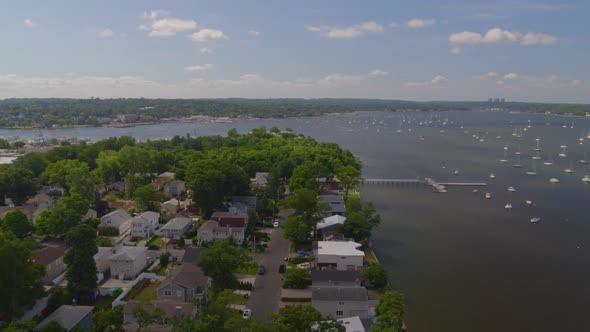 Flying Over a Suburban Neighborhood and Aerial View of Boats Anchored at Bay