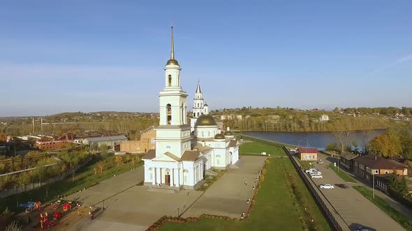 Aerial view of white Transfiguration Cathedral in autumn sunny city with pond 01