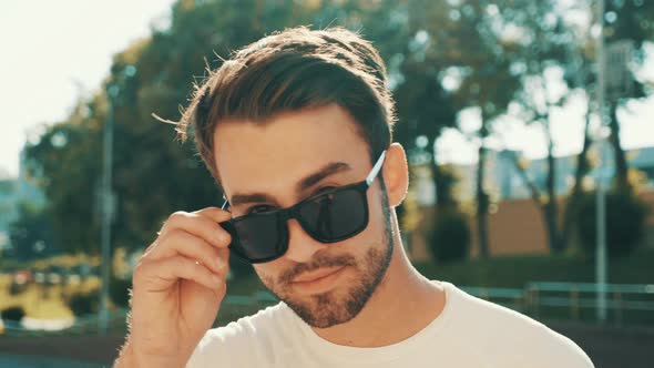 Portrait of handsome stylish hipster man posing outdoors