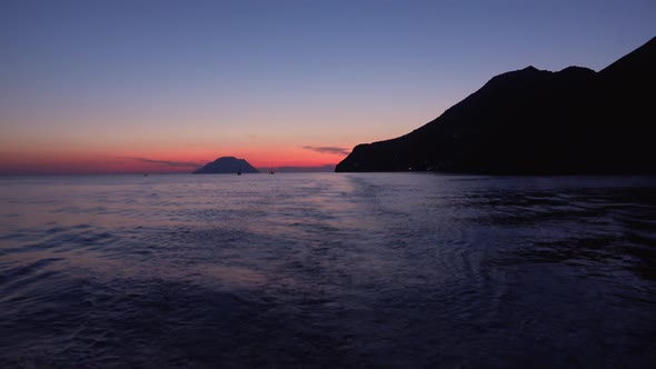 Lipari Islands in Mediterranean Sea, Horizon. Sailing Yachts and Boats in Distance. Colorful Sky