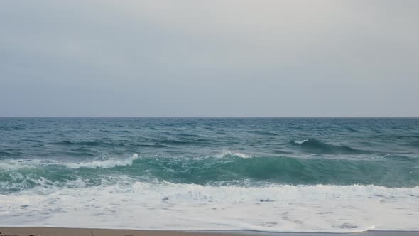 Sea waves splashing and creating white foam.