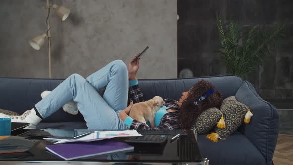 Mixed Race Woman Making Selfie with Dog Indoors