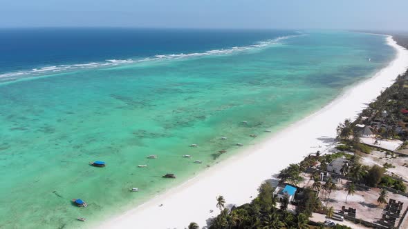 Ocean Coastline Barrier Reef By Beach Hotels at Low Tide Zanzibar Aerial View