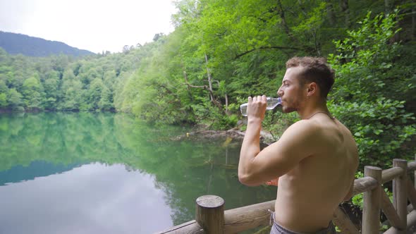 Athlete man is drinking water.