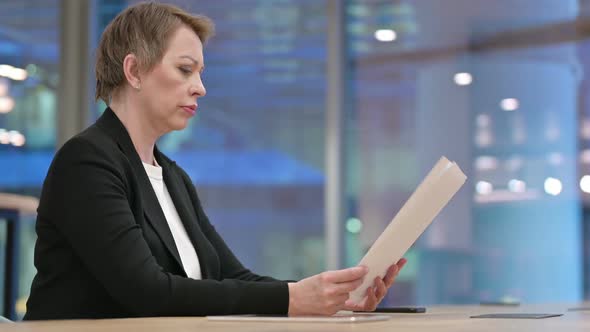 Upset Woman Reacting to Contract Reading Documents