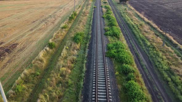 Flight Over the Railway Tracks Passing Through Agricultural Fields