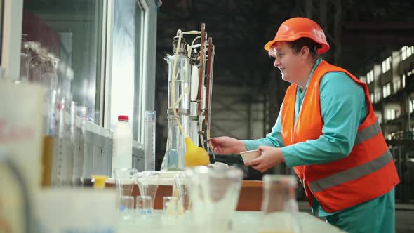 Mature Woman Working in Chemical Plant Focused Female Worker Wearing Hard Hat
