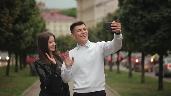 A Man and a Woman are Taking Selfies