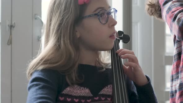 Girl playing cello during lesson