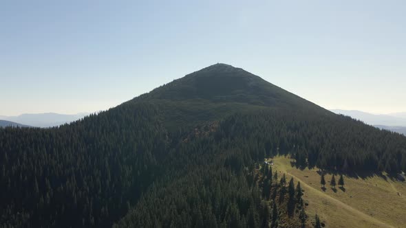 Aerial Landscape View of High Peaks with Dark Pine Forest Trees in Wild Mountains