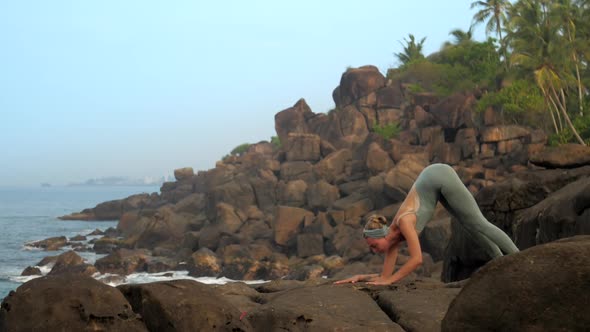 Girl Does Ardha Pincha Mayurasana on Ocean Coast Slow Motion