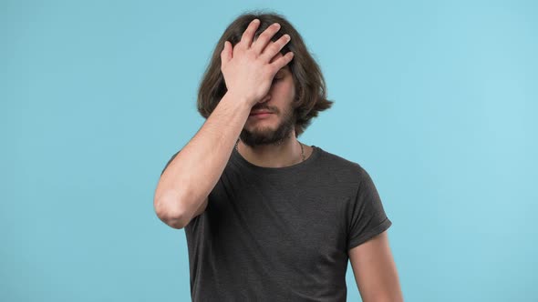 Portrait of Annoyed Bearded Man Covering Face Like Facepalm Expressing Frustration or Shame Over