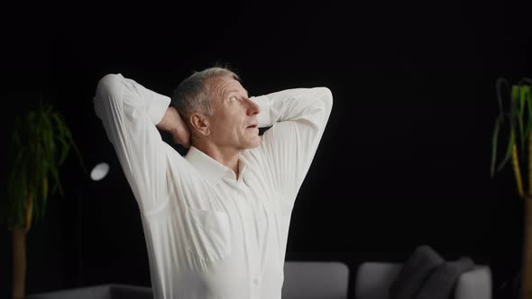 Businessman Holding Hands Behind Head Relaxing In His New Office