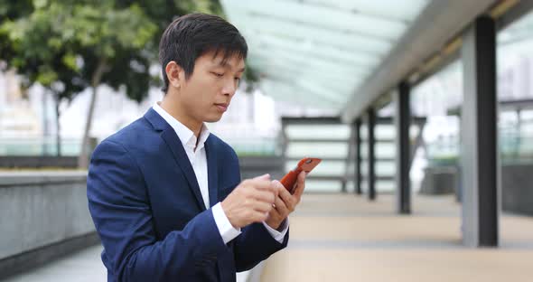 Businessman use of mobile phone at outdoor