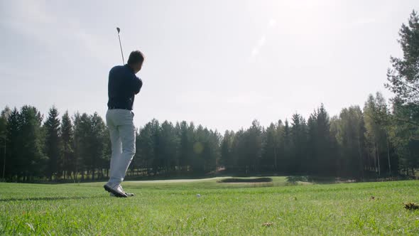 Summer Day Man Playing Golf Hits the Ball View of Golf Course in Forest Area Green Lawn