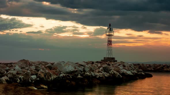 Lighthouse on a Rocky Seashore During Sunset, Timelpse