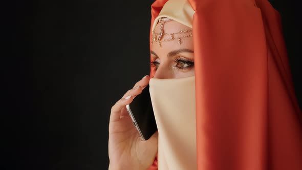 Close Up Portrait Of Beauty Young Muslim Woman In Hijab Talking On Phone.
