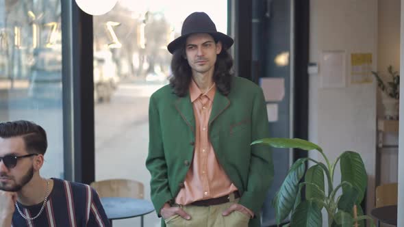 Confident 1980s Dandy Walking in Slow Motion Looking at People Sitting in Vintage Coffee Shop